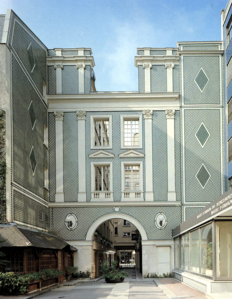A city building becomes a beautiful focal point with the help of decorative lattice work across its facade.