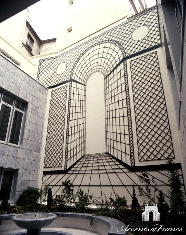 A city wall is transformed into a point of interest using a trompe l'oeil effect, creating greater depth and interest to an otherwise drab view.