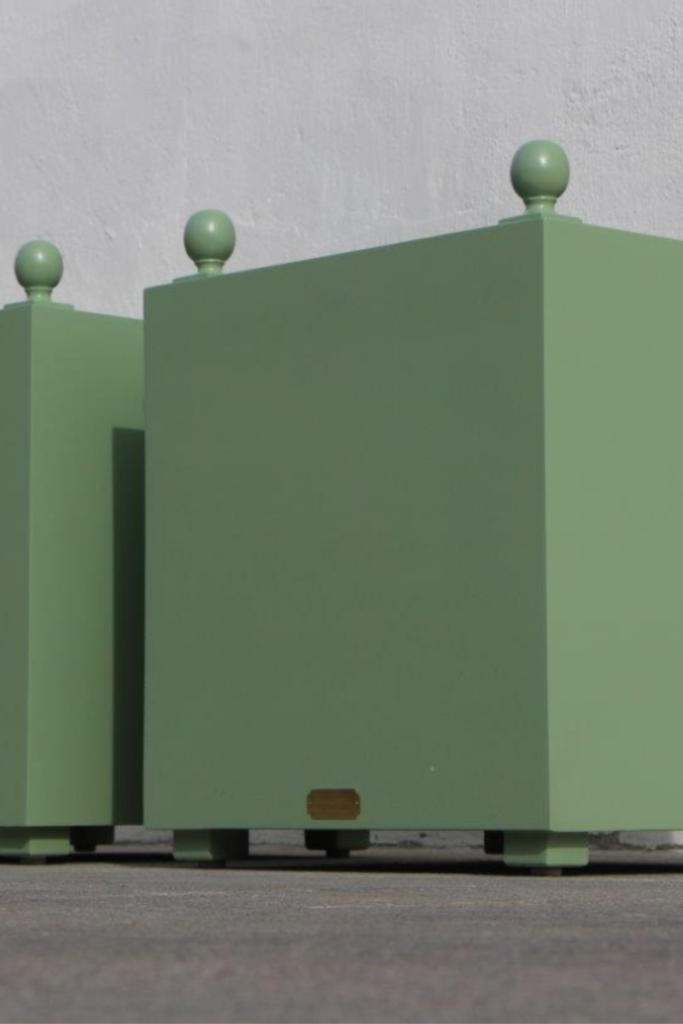 Standard Rustic-style outdoor planter box with metal liner and round ball finials. Shown in 26" with custom green paint.